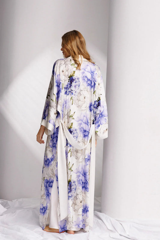 Woman wearing a long floral silk robe with wide belt-back picture