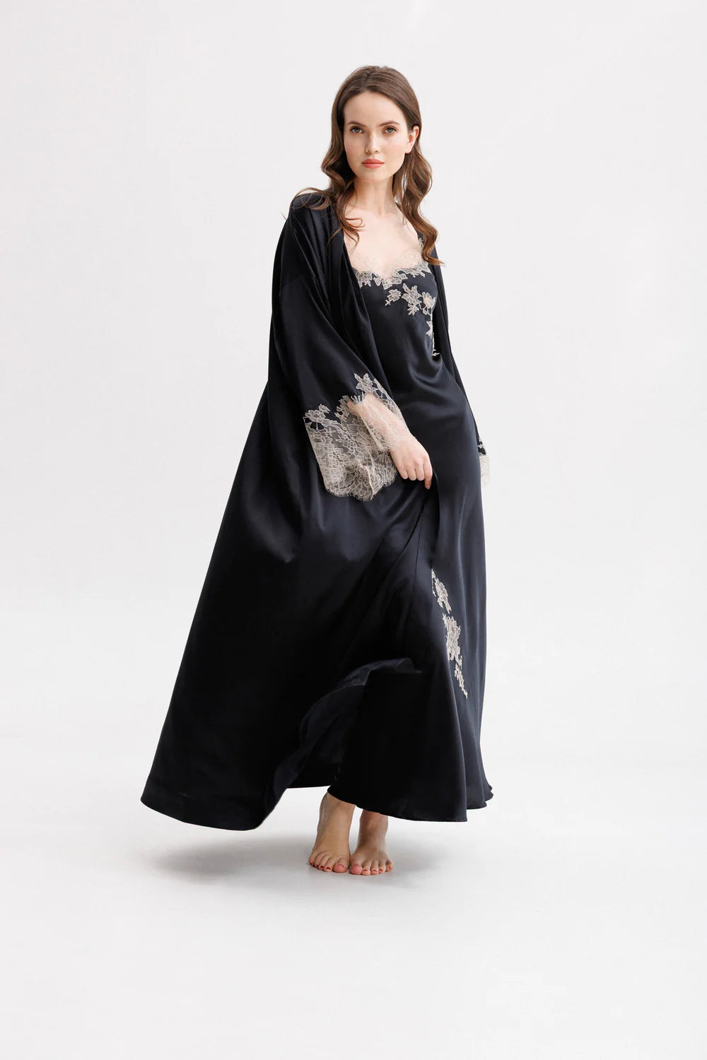 Woman wearing a black silk maxi slip dress with Leavers Lace details with matching long silk kimono (sold separately). Full front picture