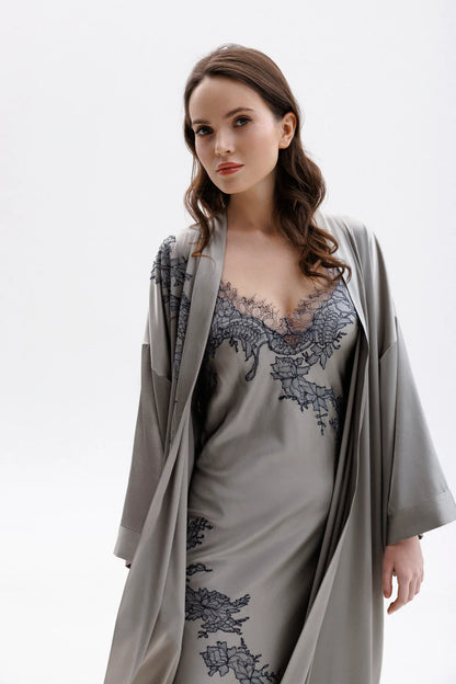 Woman wearing a gray silk nightgown with lace detailing (sold separately) and a matching elegant silk robe . 