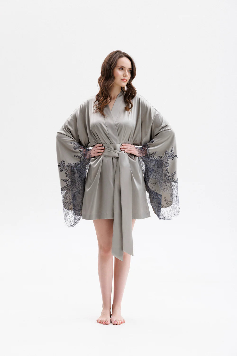 Woman wearing a gray silk robe with Leavers Lace sleeves with long wide belt