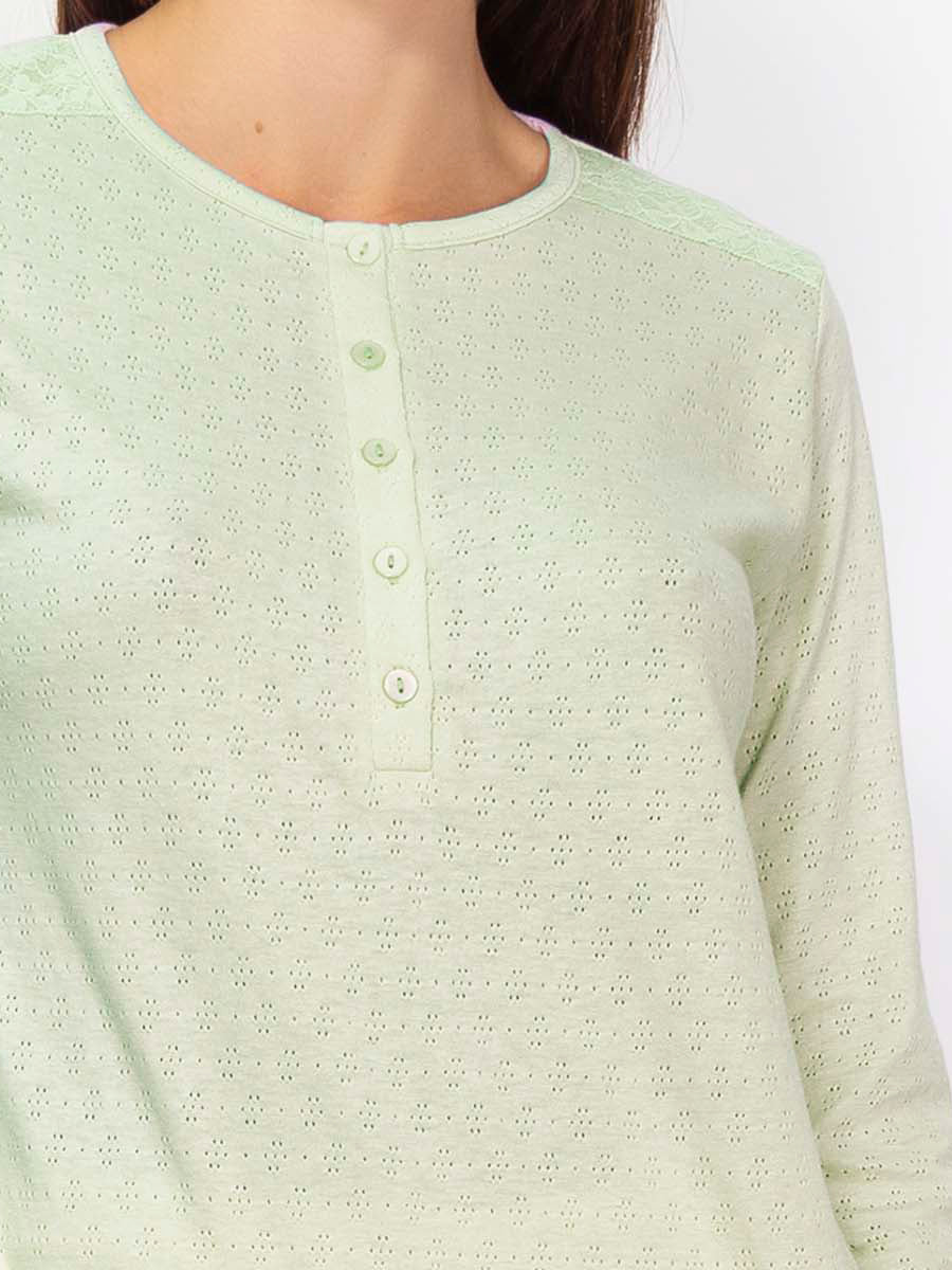 This premium pointelle cotton pajama set is crafted with a soft, subtly-textured fabric. Its long-sleeved top and trousers feature an elegant color palette that strikes a balance between comfort and style. 
