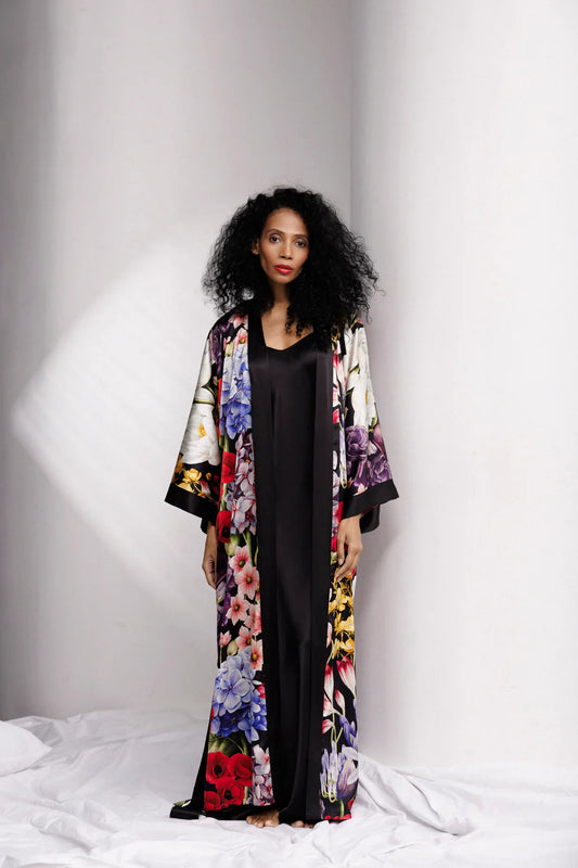 Woman wearing a colorful floral silk kimono over full length nightgown, sold separately. full front picture
