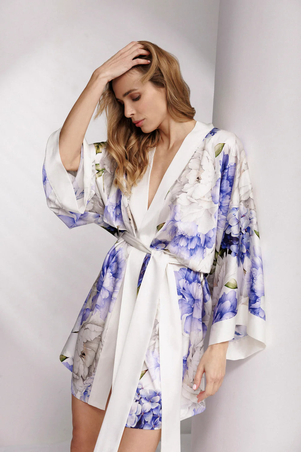 Woman wearing a silk floral short robe.