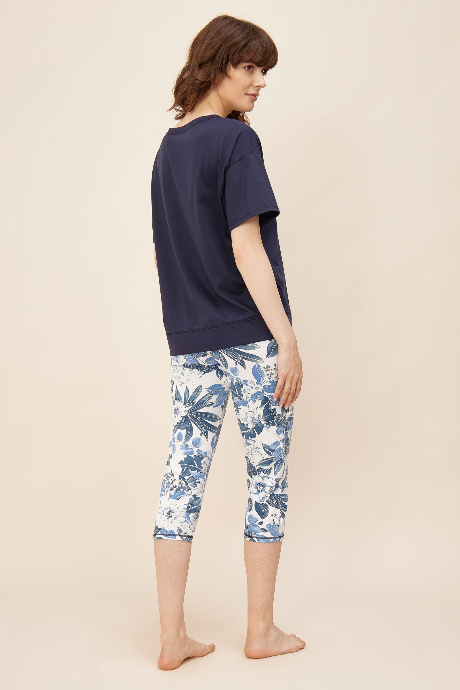 This two-piece pajama set from Rösch's Smart Casual collection is crafted from lightweight, supple single jersey cotton fabric, boasting a solid colored top and capri pants embellished with an indigo floral print.  Short sleeve  Wide crew-neck