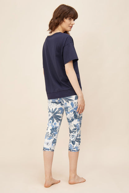 This two-piece pajama set from Rösch's Smart Casual collection is crafted from lightweight, supple single jersey cotton fabric, boasting a solid colored top and capri pants embellished with an indigo floral print.  Short sleeve  Wide crew-neck